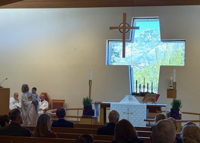 Worship in St. Alban’s sanctuary beneath the cross-shaped window.