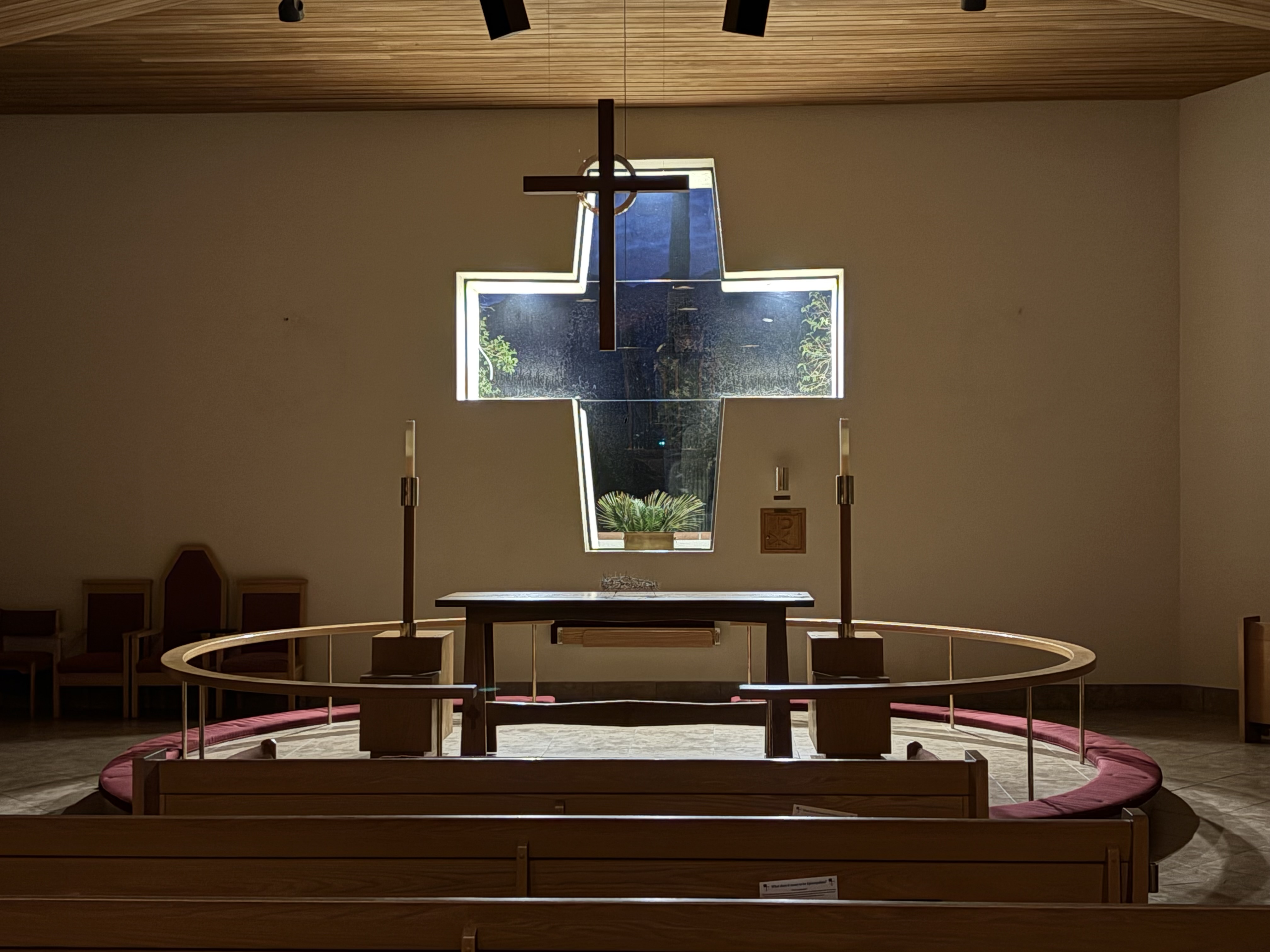 St. Alban’s altar and Communion rail beneath the cross-shaped window.